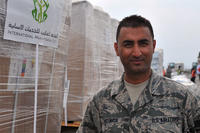 Senior Airman Manoj Khatiwada stands in front of a pallet of humanitarian assistance and disaster relief supplies at Tribhuvan International Airport in Kathmandu, Nepal, May 8, 2015. (U.S. Air Force photo/Staff Sgt. Melissa White)