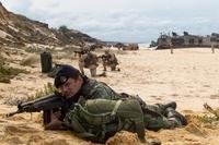 A Portuguese Marine holds security at Pinheiro Da Cruz, Praia Da Raposa beach, Portugal, while participating in a combined amphibious assault exercise, Oct. 20, 2015, during Trident Juncture 15. (Photo by: Sgt. Austin Long)