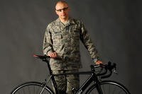 Tech. Sgt. Dwayne Farr, assigned to the Oregon Air National Guard’s 142nd Aircraft Maintenance Squadron, poses with one of his bicycles on Portland Air National Guard Base, Ore., April 7, 2013. (U.S. Air National Guard photo/Tech. Sgt. John Hughel)