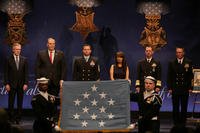 Members of the U.S. Navy Ceremonial Guard display the Medal of Honor flag during a Hall of Heroes induction ceremony for Edward C. Byers Jr. (U.S. Navy photo by Oscar Sosa/Released)