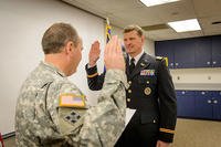 Col. Leo Ryan, left, administers the oath of office to newly-promoted Lt. Col. Brock Larson during a ceremony Jan. 9, 2015. (U.S. Army National Guard photo by Staff Sgt. Brett Miller, Joint Force Headquarters)