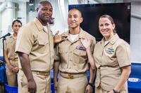 GSEC Alexis Ortiz, center, receives his chief petty officer (CPO) anchors from ITC Larry Ward and ISC Shauntel Moon after being promoted aboard the USS Stethem (DDG 63). (U.S. Navy/Ensign Rebecca Speer)