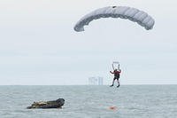 An Air Force Reserve pararescueman descends into the Atlantic Ocean from a C-17 Globemaster III to recover a NASA astronaut as part of an exercise Jan. 14, 2016, off the shore of Cape Canaveral Air Force Station, Fla. (U.S Air Force /Matthew Jurgens)