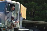Sgt. 1st Class Matthew Caster takes instructions about how to properly parallel park a large truck Aug. 2 as part of a commercial driver's license pilot program on Fort Lee. (Photo Credit: Amy Perry)