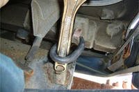 Using a wrench to install an exhaust hanger