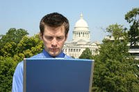 man on latop in front of Capitol building