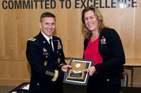 Retired Navy SEAL Kristin Beck receives a plaque in June 2014 from Defense Intelligence Agency Director Lt. Gen. Michael Flynn, following the agency’s Pride Month event. (DIA photo)