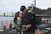 Chief Logistics Specialist Kyle Bryant, assigned to USS Nevada, embraces his family as he returns to Naval Base Kitsap-Bangor on March 21, 2017, following a routine strategic deterrent patrol. Mass Communication Specialist 1st Class Amanda R. Gray/Navy