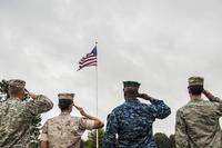Service members salute the U.S. flag during a Retreat ceremony Oct. 2, 2014, at Little Rock Air Force Base, Ark. Airman 1st Class Harry Brexel/Air Force