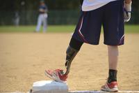 A Wounded Warrior Amputee Softball Team member stands on first base during a game in Newport News, Va., on April 15, 2017. Coapt Engineering is working to adapt its system to power leg prosthetics. Airman 1st Class Kaylee Dubois/Air Force