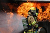 Firefighter beats back blaze.
