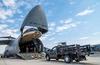 Airmen load a truck onto a C-5M Super Galaxy.