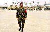 Abdul Wasi Safi stands in the foreground of Afghan military vehicles