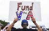 A demonstrator holds a sign at a Unite for Veterans rally, Friday, June 6, 2025, on the National Mall