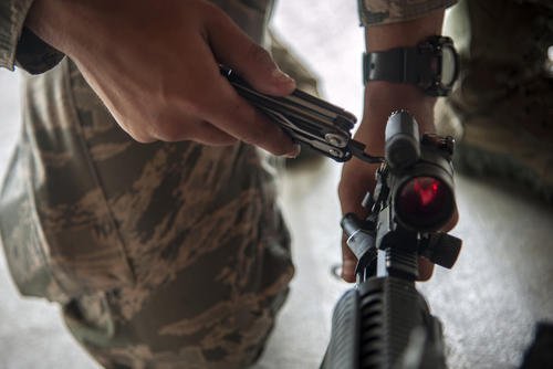 An airman utilizes a pocket knife to adjust the sight on a M4 carbine at Moody Air Force Base, Georgia, April 4, 2018. (Airman Eugene Oliver/U.S. Air Force photo)