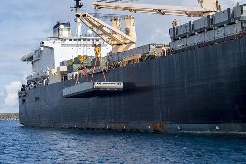 Sailors maneuver a docking module for the Improved Navy Lighterage System (INLS) over the side of the Military Sealift Command maritime prepositioning force ship USNS 2nd Lt. John P. Bobo (T-AK 3008) on Apra Harbor, Guam.