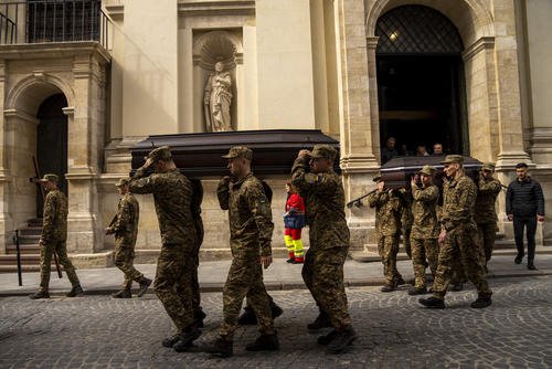 Soldiers carry the coffins of two Ukrainian army sergeants during their funeral in Lviv, Ukraine