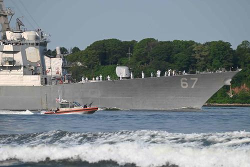 U.S. Coast Guard boat escorts the USS Cole into the New York Harbor