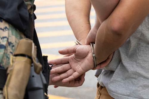 A military police officer restrains an individual during an exercise