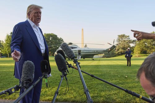 President Donald Trump speaks with reporters