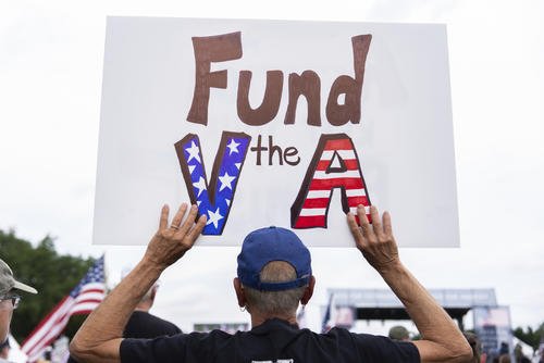 A demonstrator holds a sign at a Unite for Veterans rally, Friday, June 6, 2025, on the National Mall