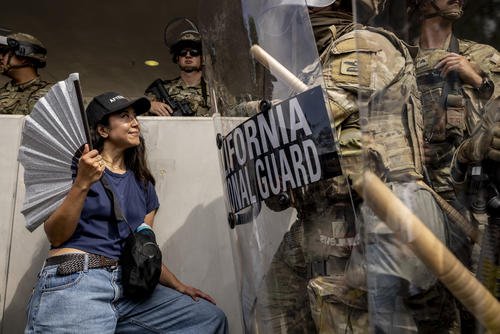 Protester standing in front of a California National Guard