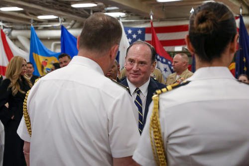 Secretary of the Navy John Phelan greets guests during a welcome reception