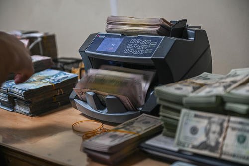 Cash counter machine flips through U.S. currency bills