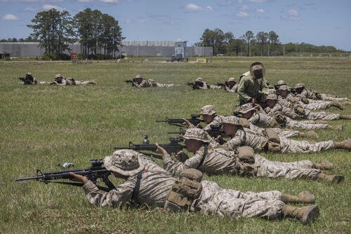 A U.S. Marine Corps drill instructor teaches one recruit how to sight his weapon during a dry-fire rifle training exercise, Wednesday, May 11, 2022, in Parris Island, SC. (AP Photo/Stephen B. Morton)