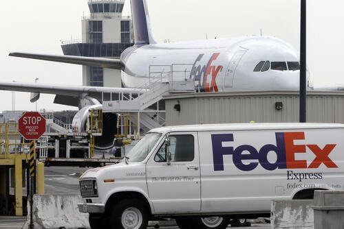 A FedEx plane is shown with a FedEx van in foreground at a FedEx hub at the Oakland Airport in Oakland, Calif., Monday, Jan. 12, 2011. (AP Photo/Paul Sakuma)