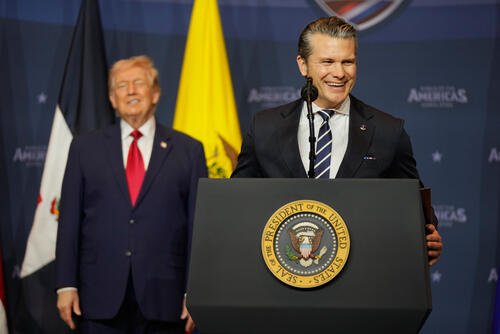 Defense Secretary Pete Hegseth, right, speaks President Donald Trump listens during the Shield of the Americas Summit, Saturday, March 7, 2026, at Trump National Doral Miami in Doral, Fla. (AP Photo/Mark Schiefelbein)