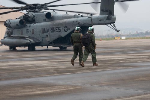 U.S. Marines with Marine Heavy Helicopter Squadron 466, Marine Aircraft Group 36, 1st Marine Aircraft Wing walk toward a CH-53E Super Stallion helicopter on Suwon Air Base, Gyeonggi-do, South Korea, April 6, 2026, after Korean Marine Exchange Program 26.1. (U.S. Marine Corps photo by Cpl. Jeremiah Barksdale)
